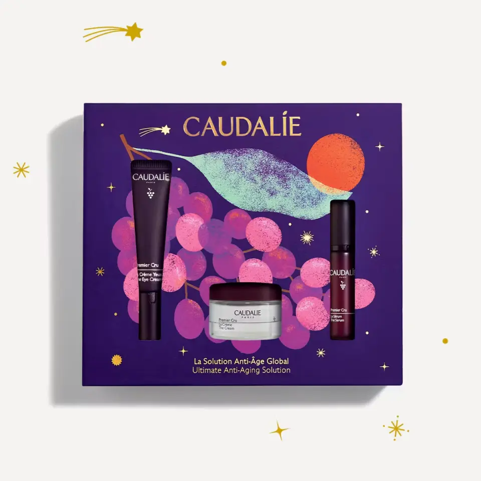 Caudalie skincare gift set with eye cream, serum, and cream on purple grape-themed box.
