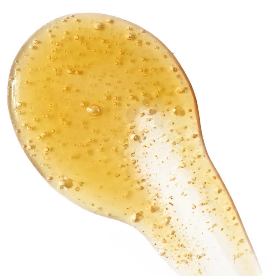 Golden gel with bubbles on a white background.