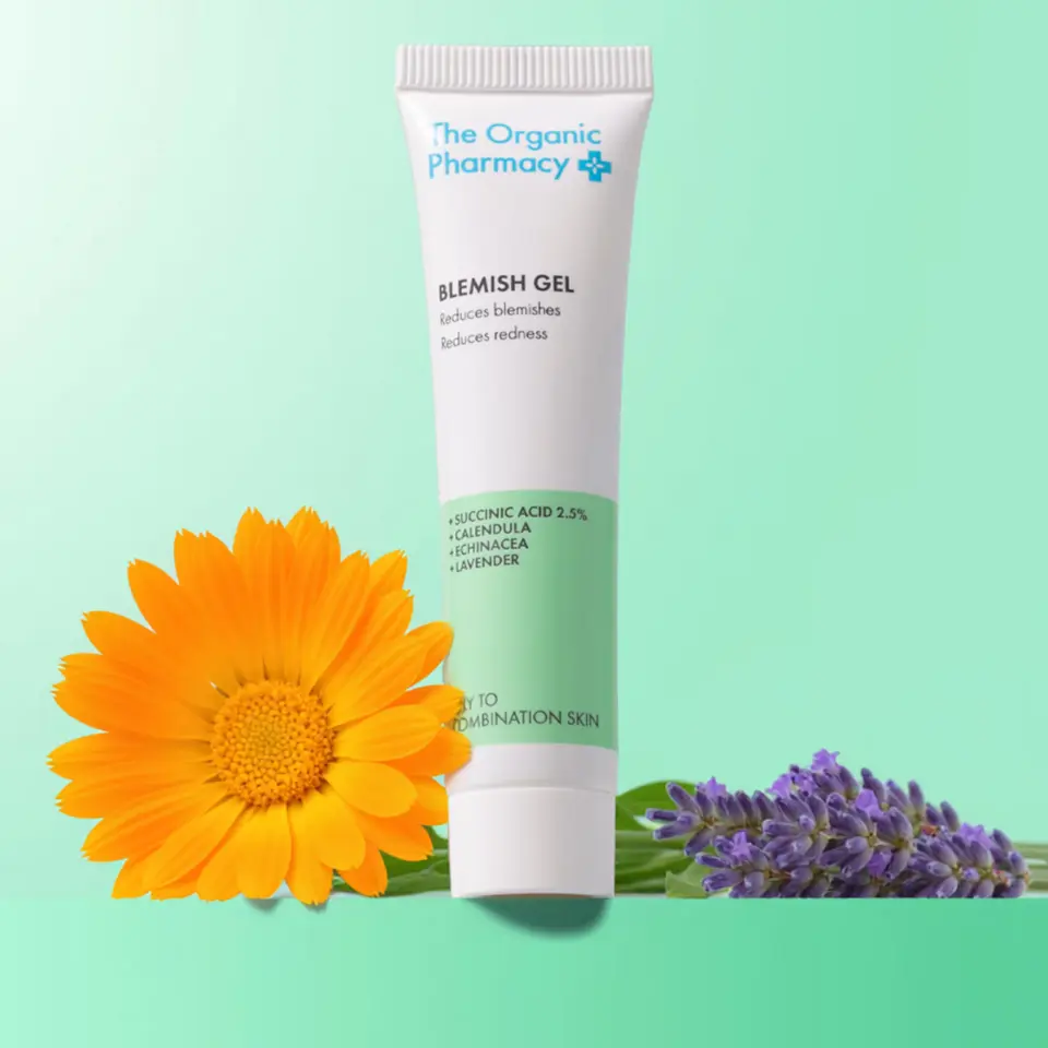 Blemish gel tube with calendula and lavender flowers on green background.