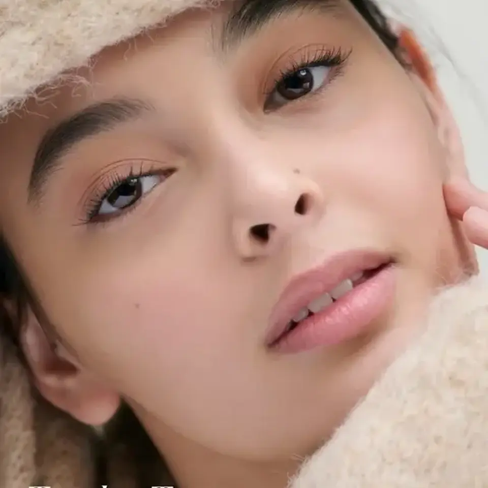 Close-up of a person wearing taupe knitwear. Text reads "Tundra Taupe".