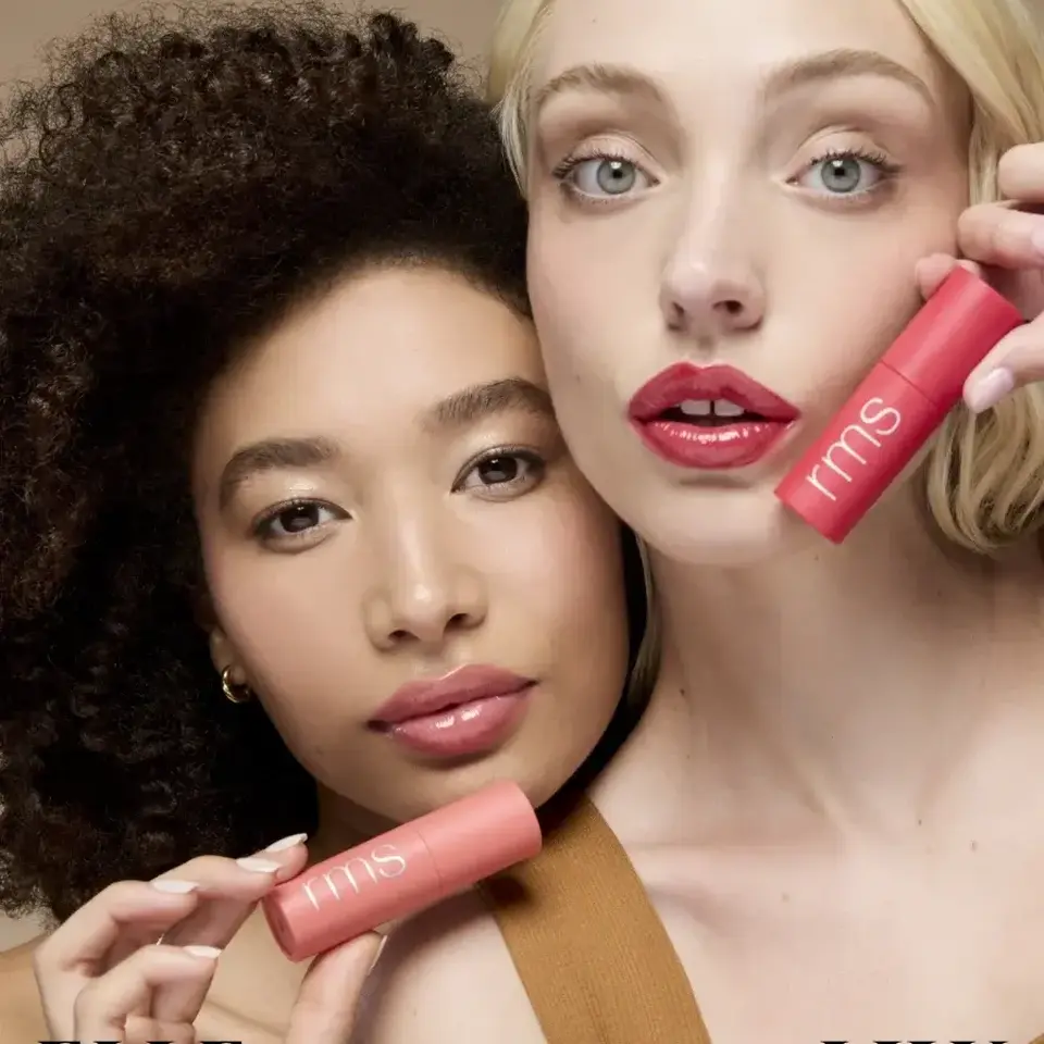 Two women holding pink rms beauty products, text "ELLE" and "LILY" below.