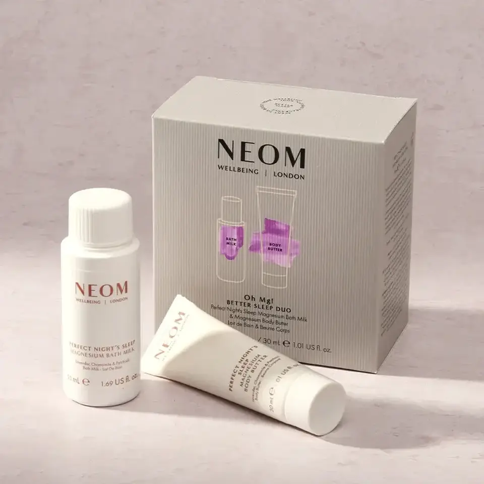NEOM Better Sleep Duo set with bath milk and body butter on a light surface.