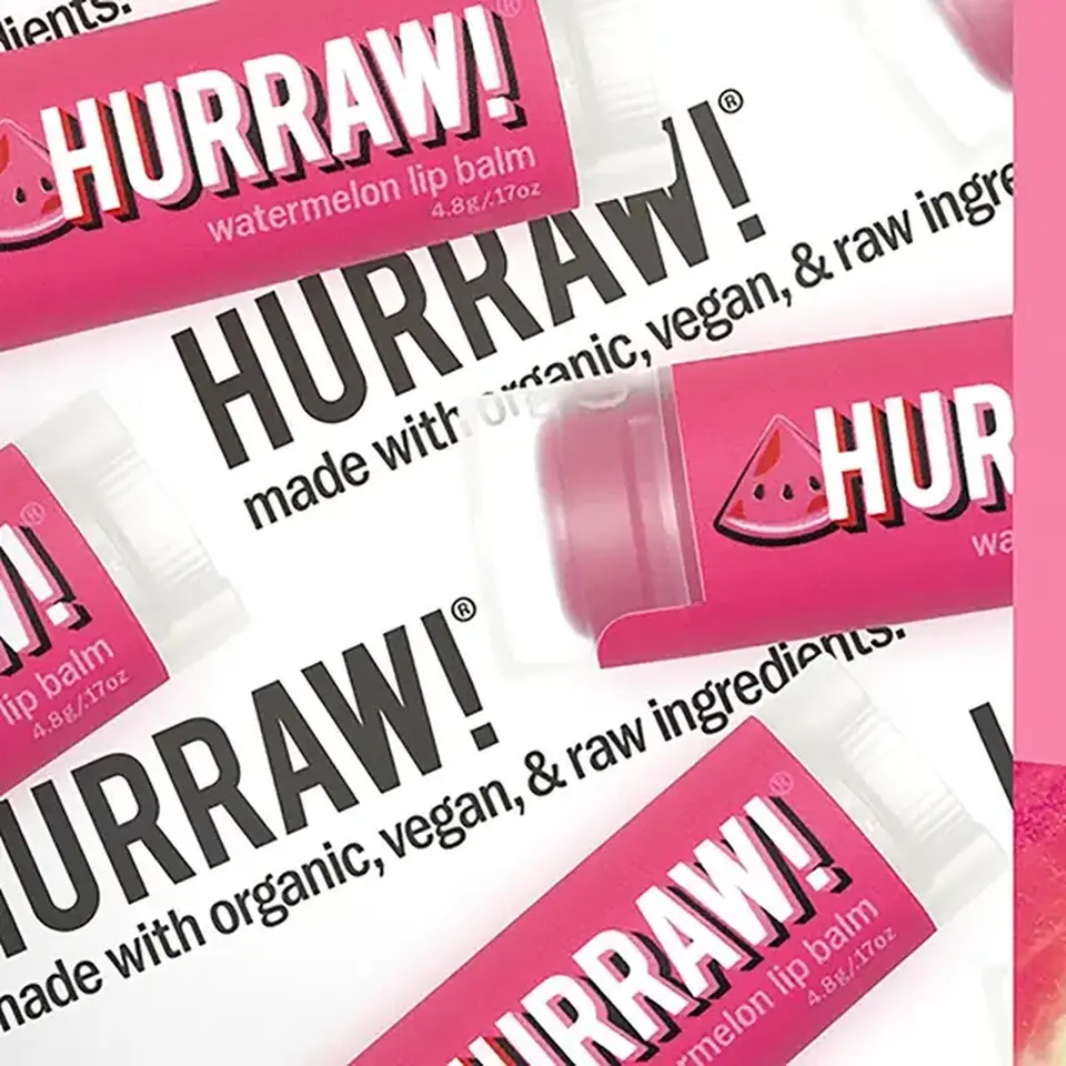 Pink Hurraw! watermelon lip balm tubes with text on organic, vegan ingredients.