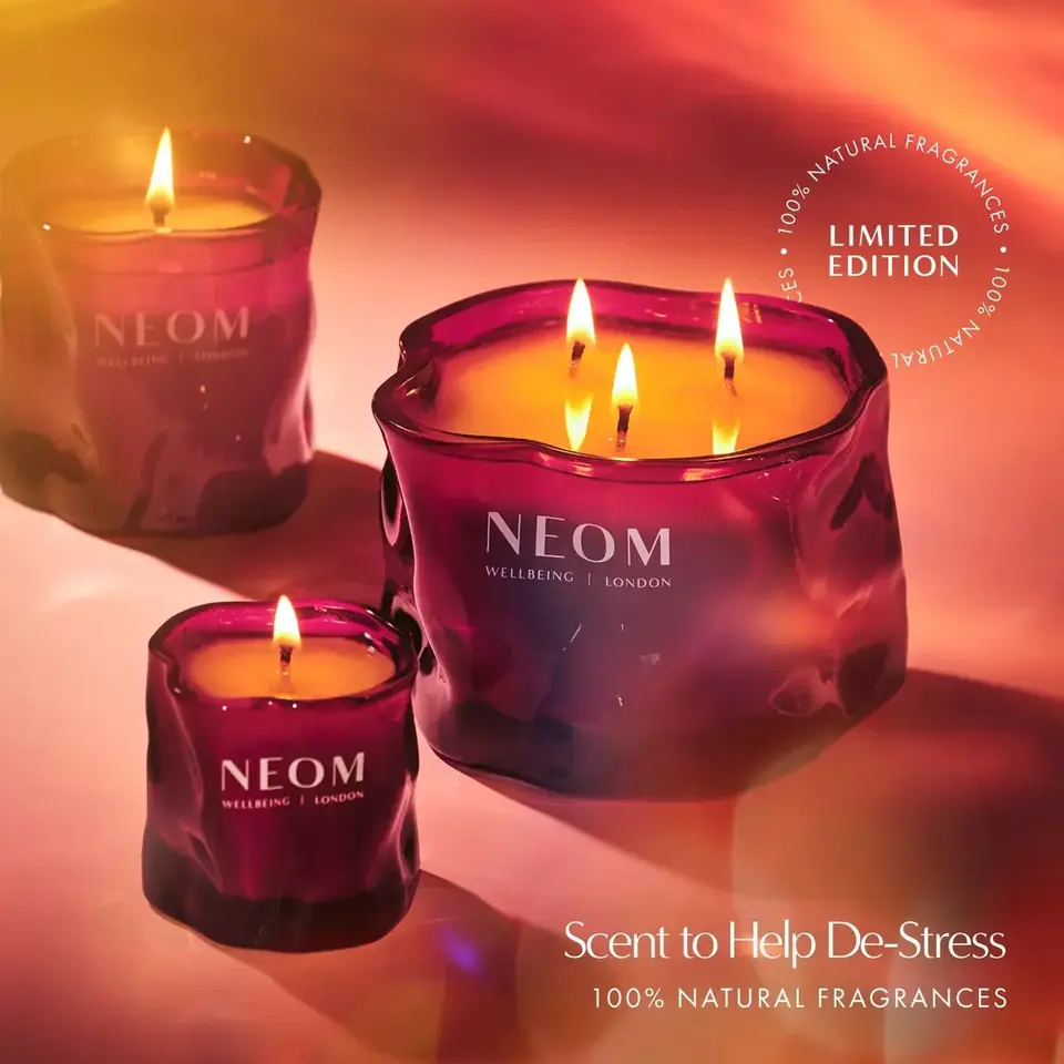 Purple NEOM candles with flames, text: "Limited Edition, Scent to Help De-Stress".