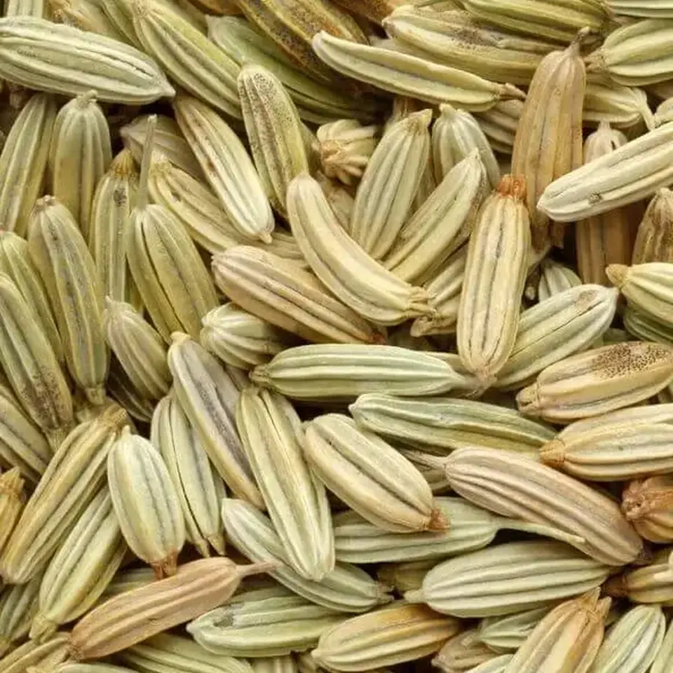 Close-up of dried fennel seeds in various shades of green and brown.