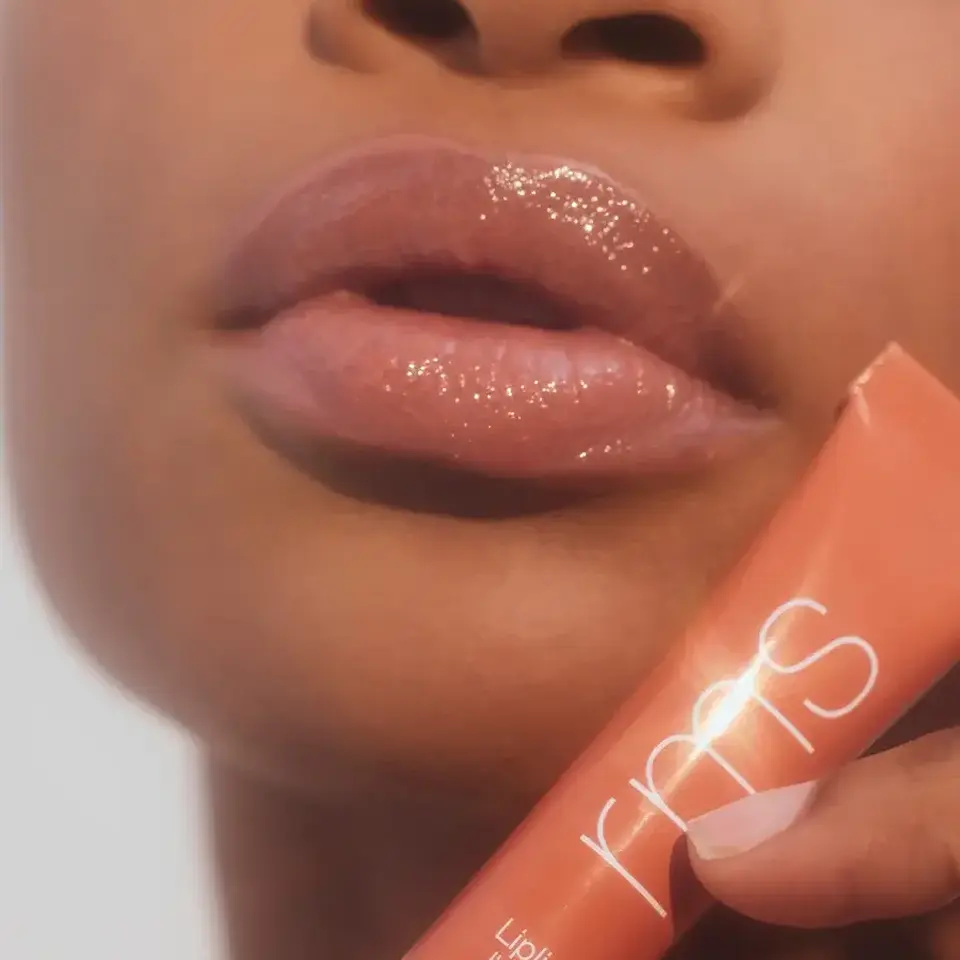 Close-up of glossy lips with RMS lip gloss tube. Text: "Liplights" and "BISOU".