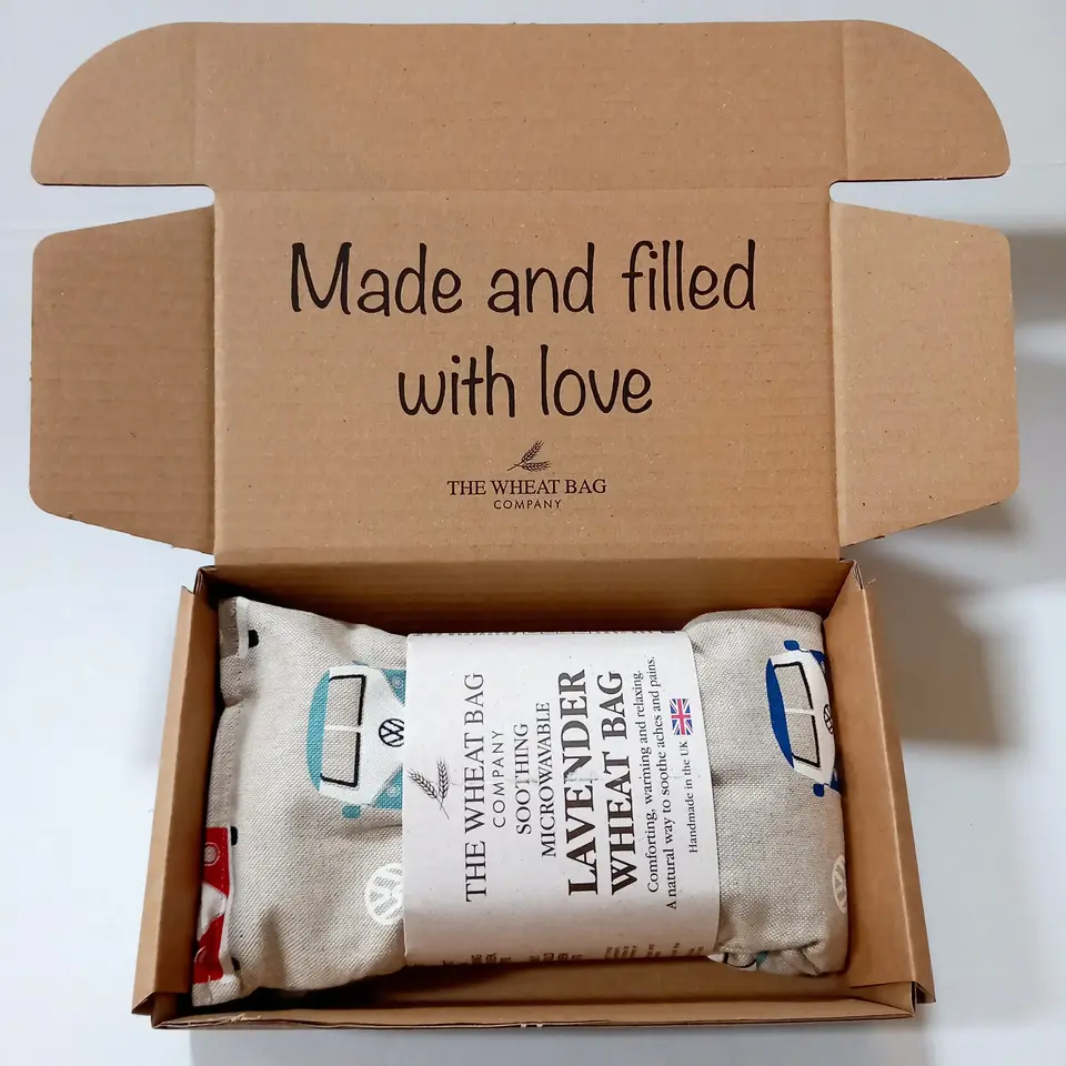 Open box with a lavender wheat bag inside. Text: "Made and filled with love".