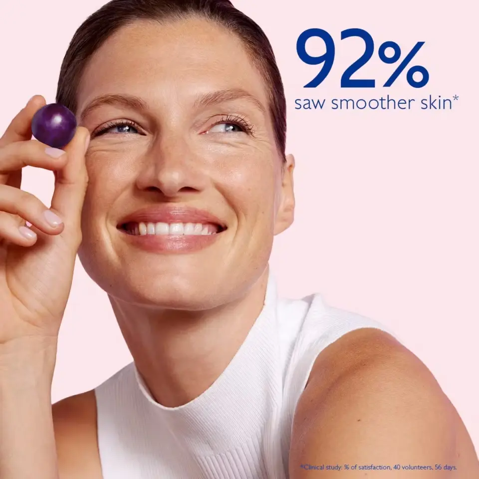 Woman holding a purple sphere, text reads "92% saw smoother skin".