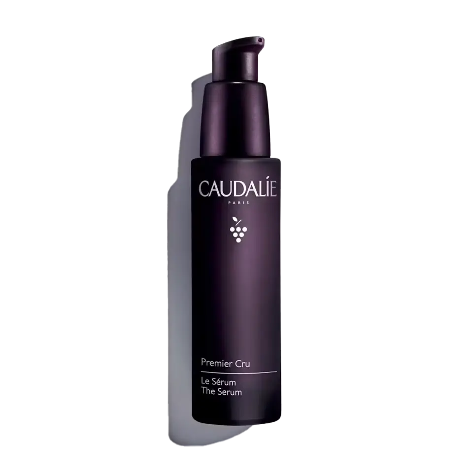 Dark purple bottle of Caudalie Premier Cru Le Sérum with pump dispenser.