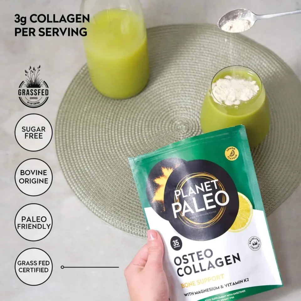 Hand holding Planet Paleo Osteo Collagen packet, green drink on mat, spoon with powder above.