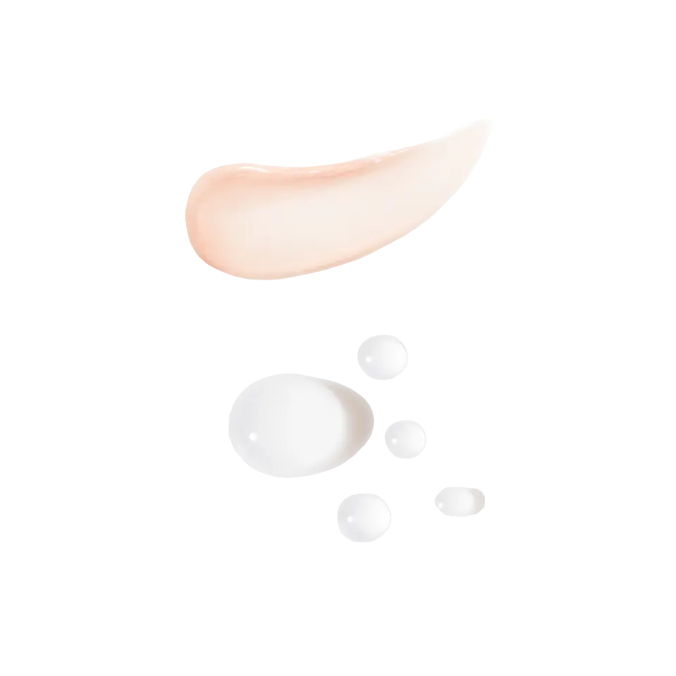 Peach cream smear and white serum droplets on black background.