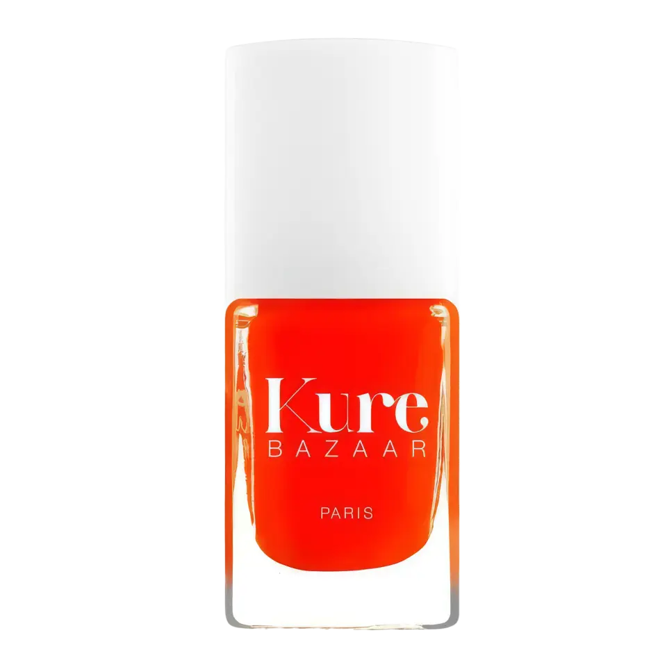 Kure Bazaar Paris nail polish in bright orange with a white cap.