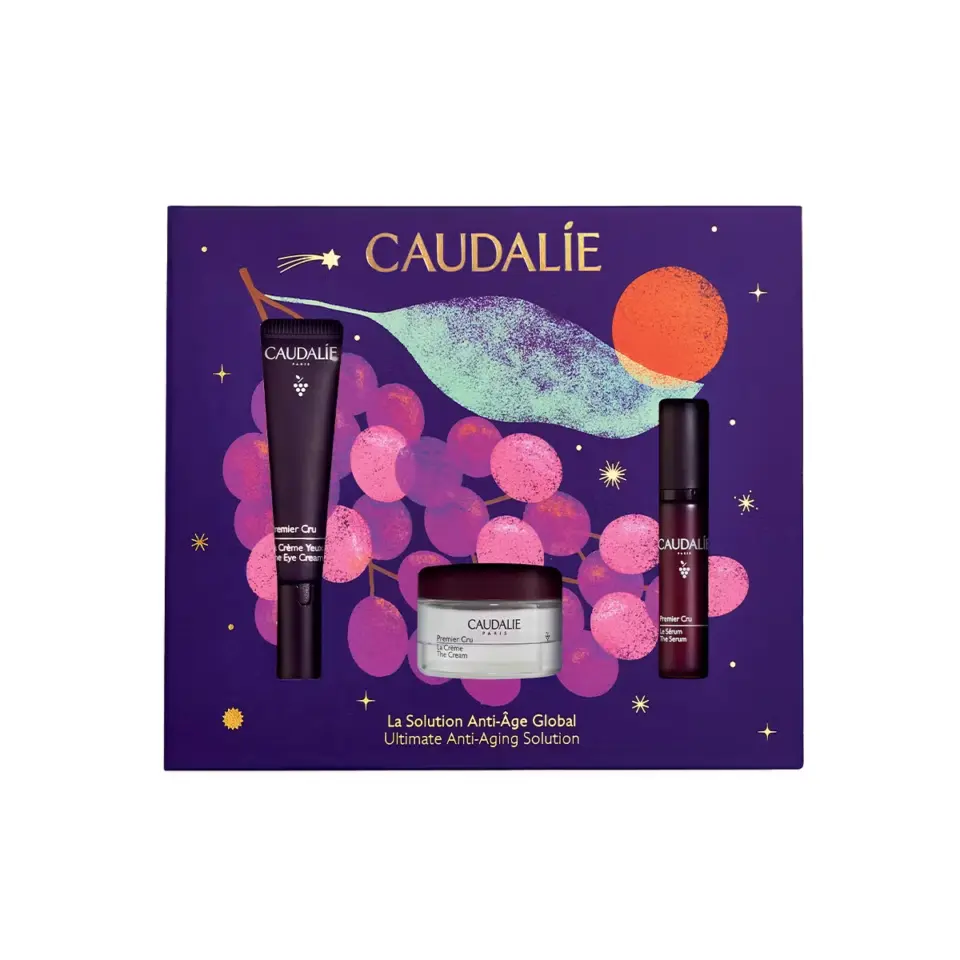 Caudalie skincare set with eye cream, serum, and cream on a purple grape-themed box.
