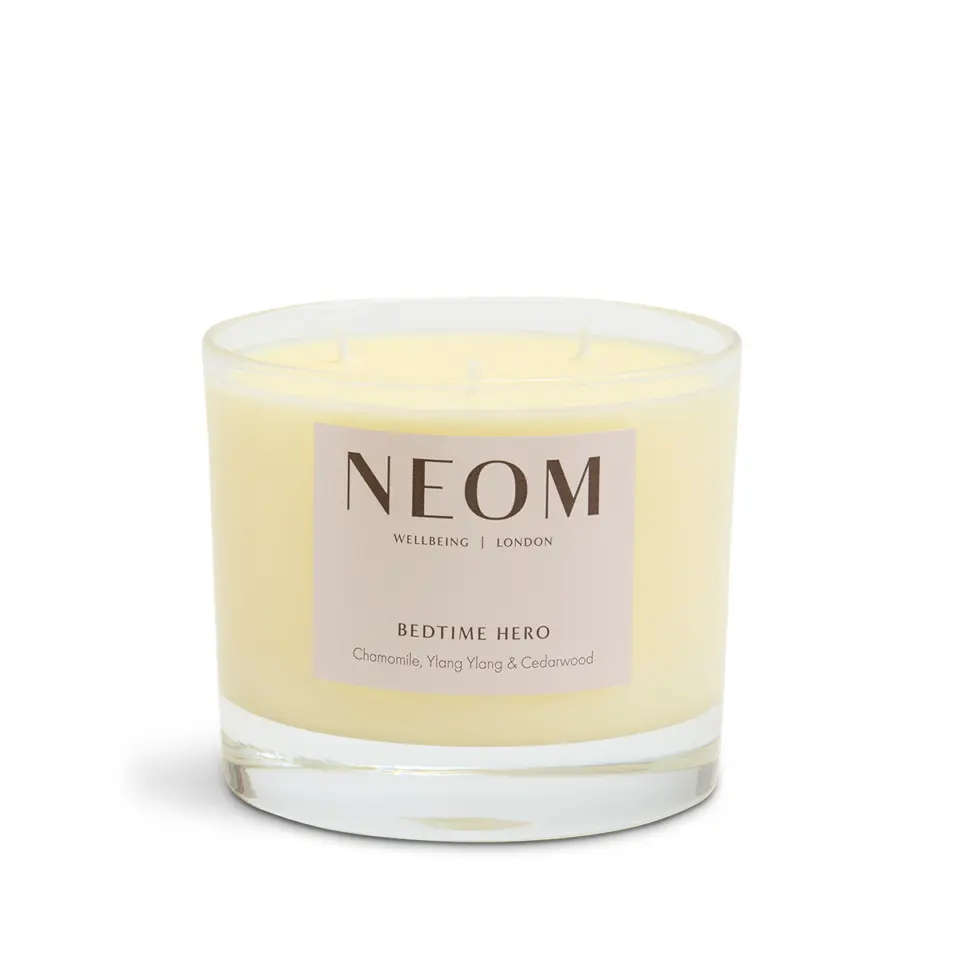 NEOM Bedtime Hero candle with chamomile, ylang ylang, and cedarwood in a glass jar.
