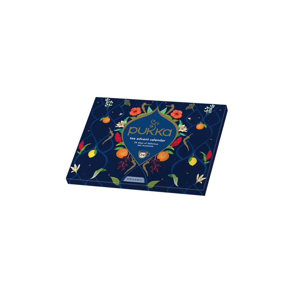 Pukka tea advent calendar box with floral and fruit design on a dark background.