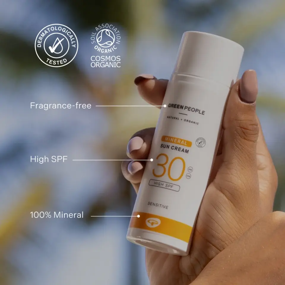 Hand holding Green People SPF 30 mineral sun cream. Fragrance-free, 100% mineral.