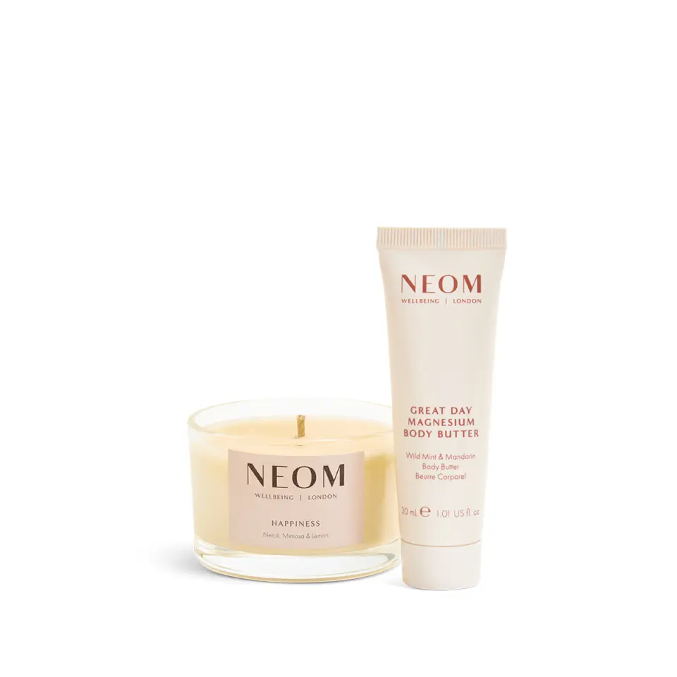 Neom candle and body butter. Candle labelled "Happiness". Body butter labelled "Great Day Magnesium".