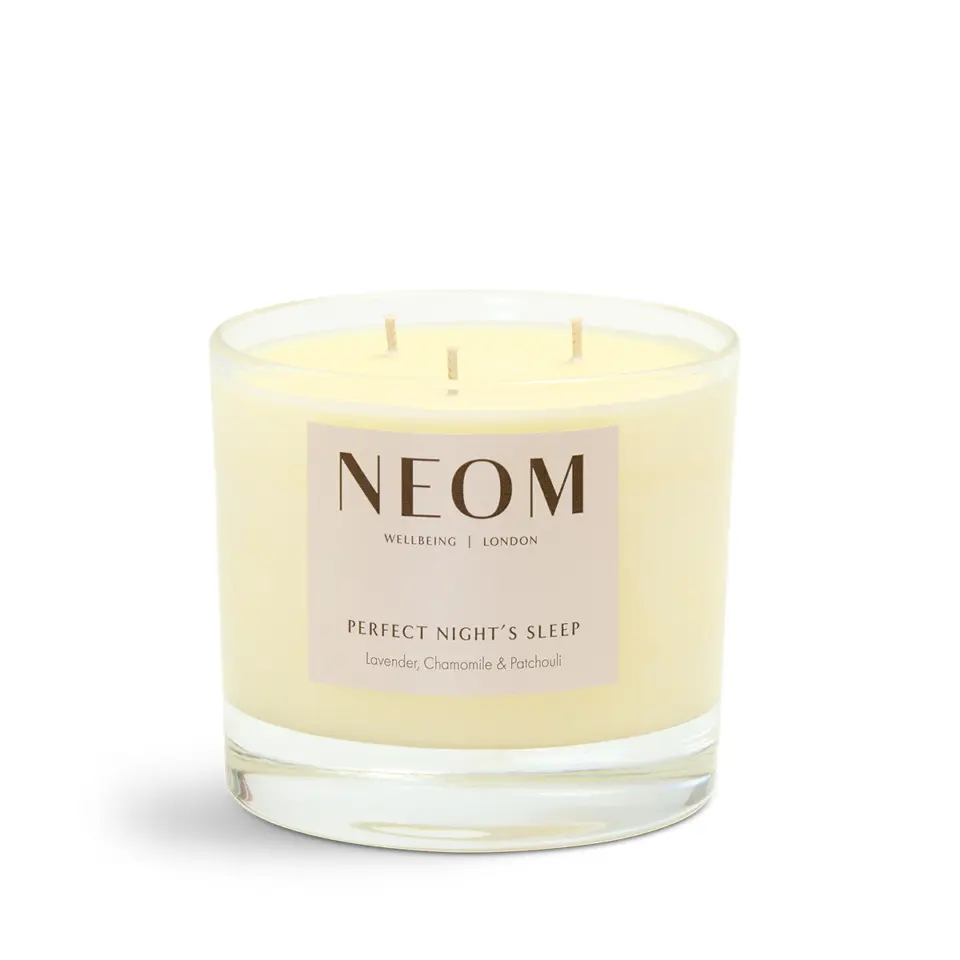 NEOM candle with lavender, chamomile, and patchouli scent in a glass jar.