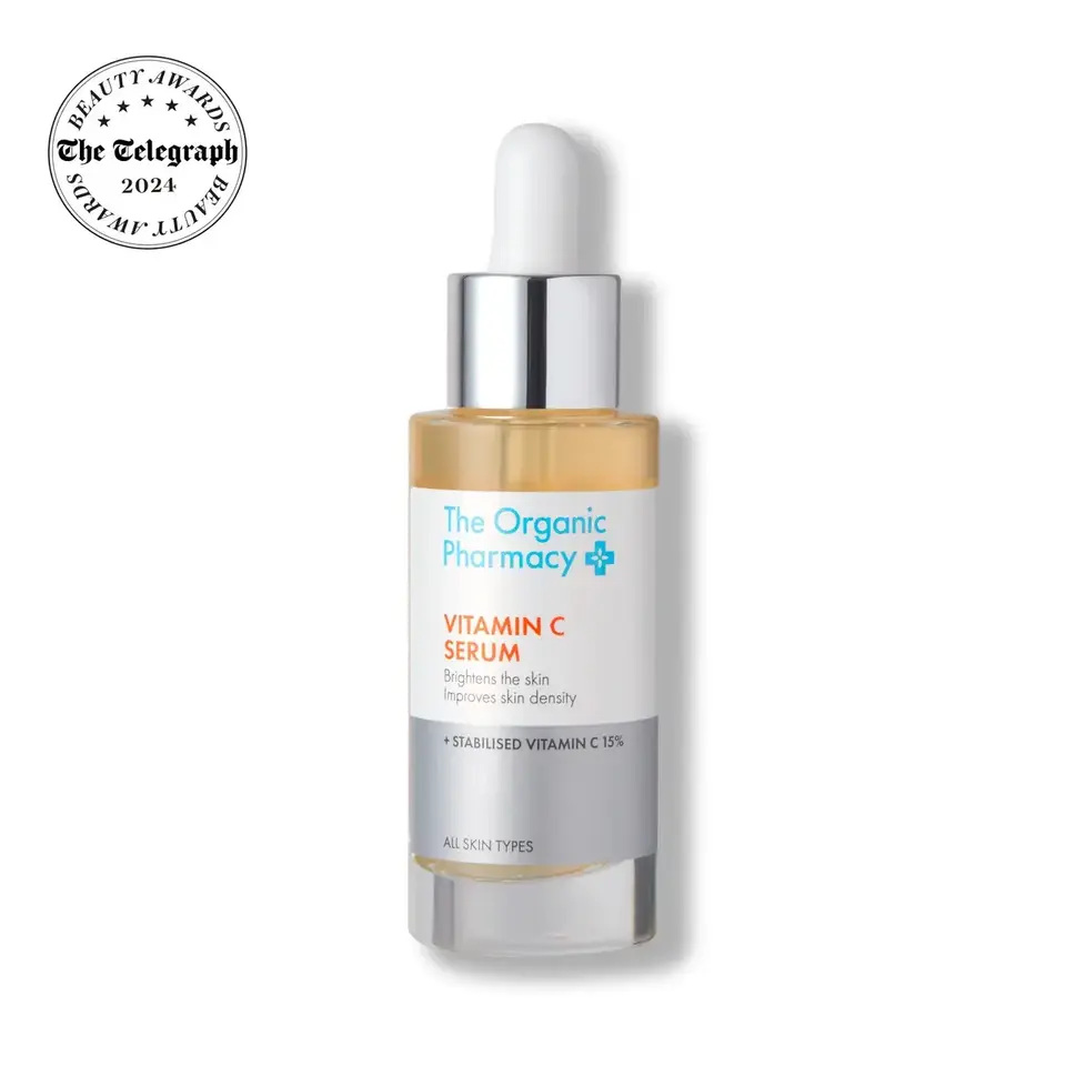 The Organic Pharmacy Vitamin C Serum bottle with dropper and award badge.