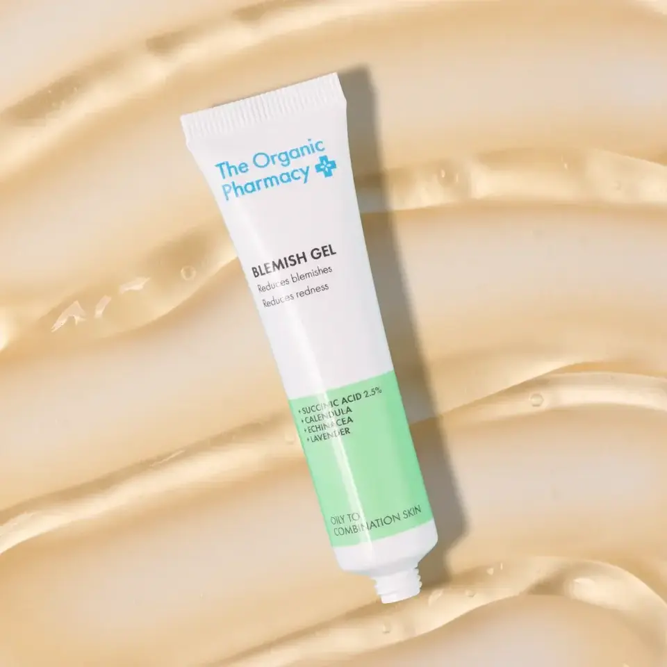 The Organic Pharmacy Blemish Gel tube on a beige background.