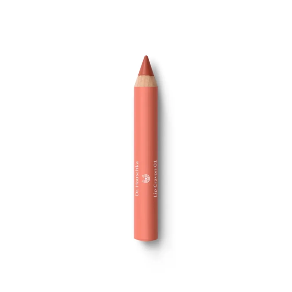 Coral lip crayon with "Dr. Hauschka Lip Crayon 01" text on white background.