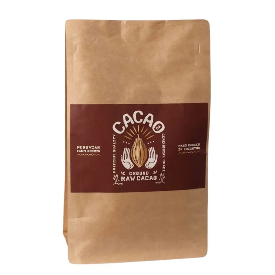 Brown paper bag of ground raw cacao, Peruvian origin, hand packed in Brighton.