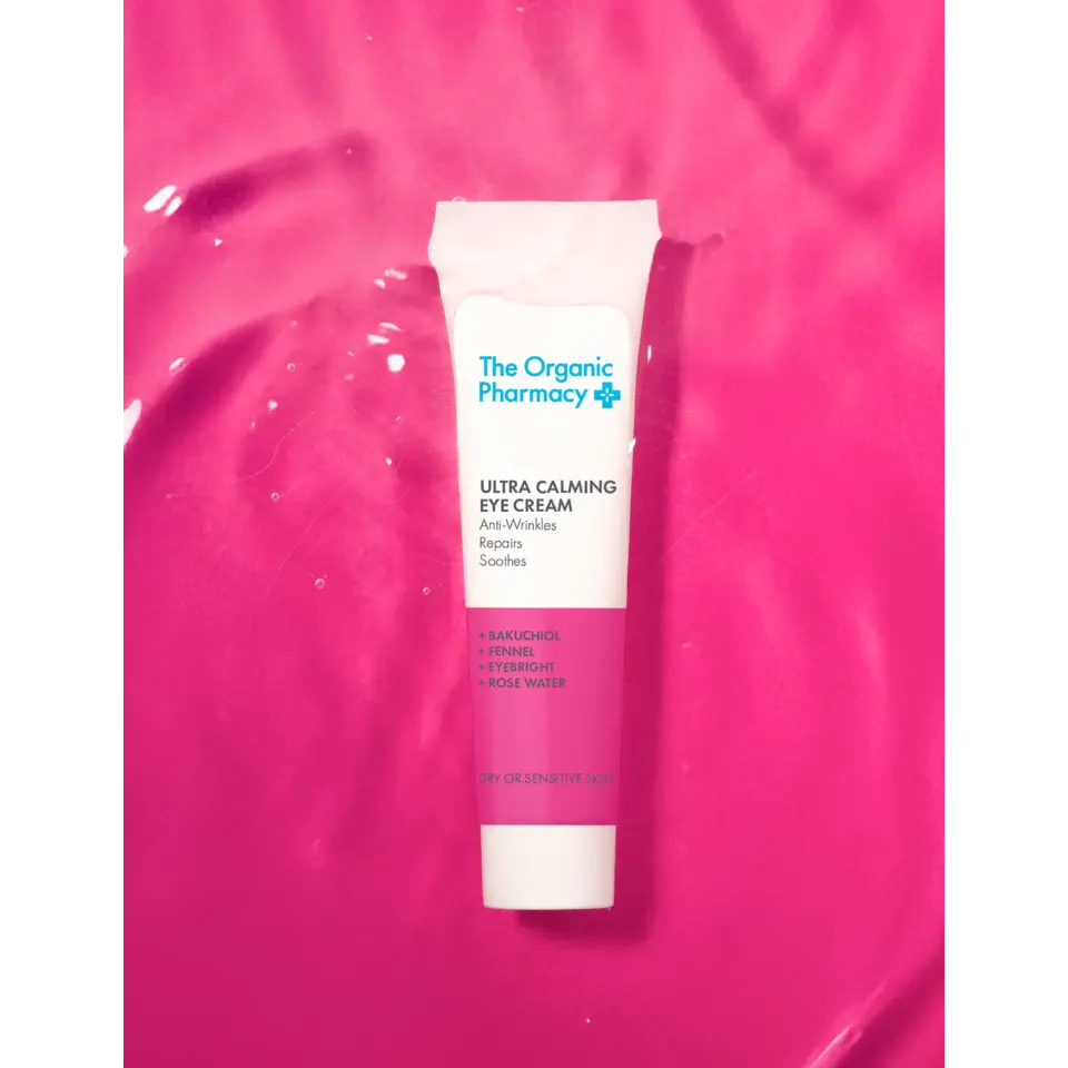Tube of Ultra Calming Eye Cream on a pink background.