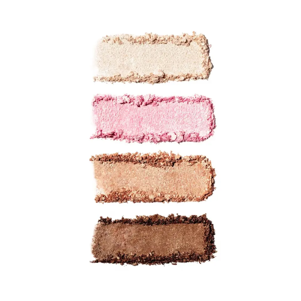 Four swatches of eyeshadow: cream, pink, bronze, and brown on white background.