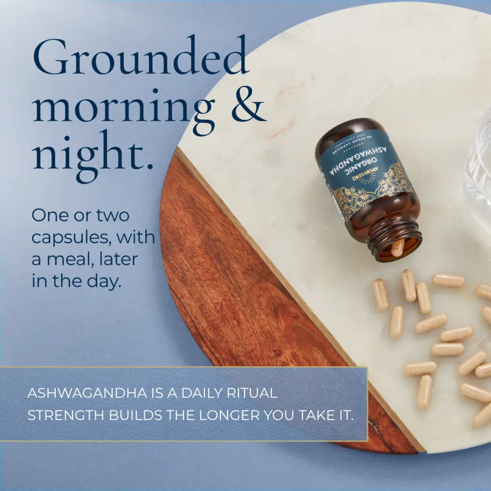 Ashwagandha capsules on a marble surface. Text: "Grounded morning & night.