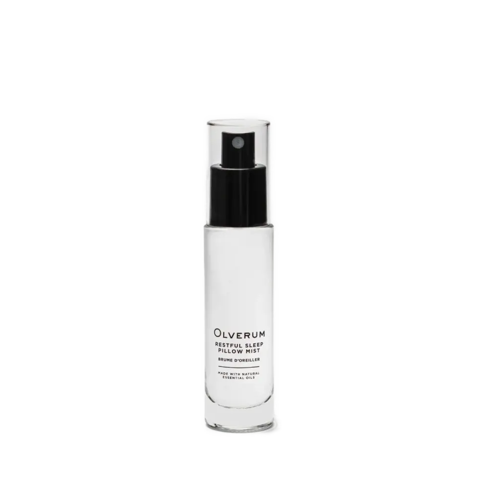 Clear bottle of Olverum Restful Sleep Pillow Mist with black spray top.