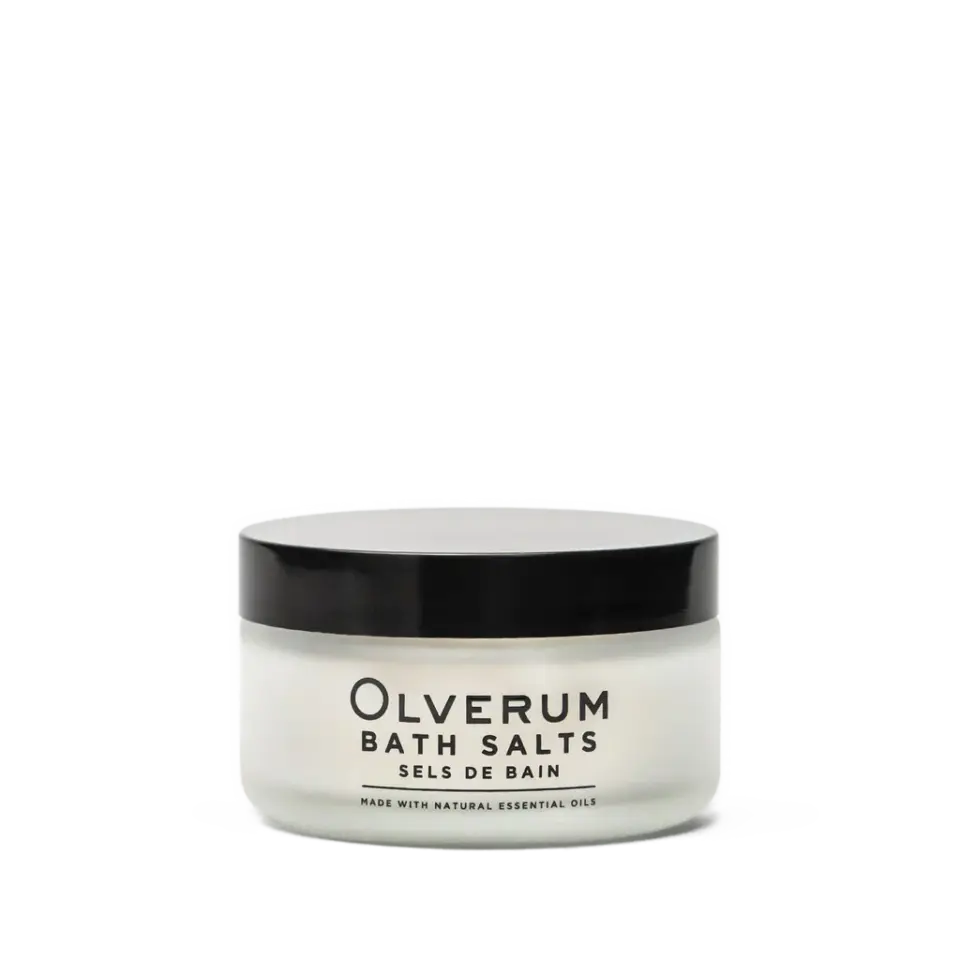 Olverum Bath Salts jar with black lid, labelled with essential oils.
