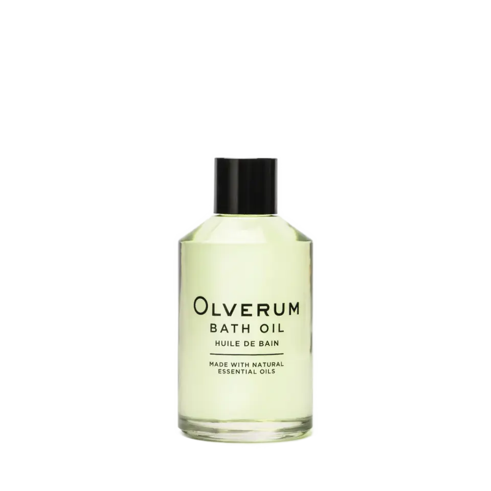 Clear bottle of Olverum bath oil with black cap.