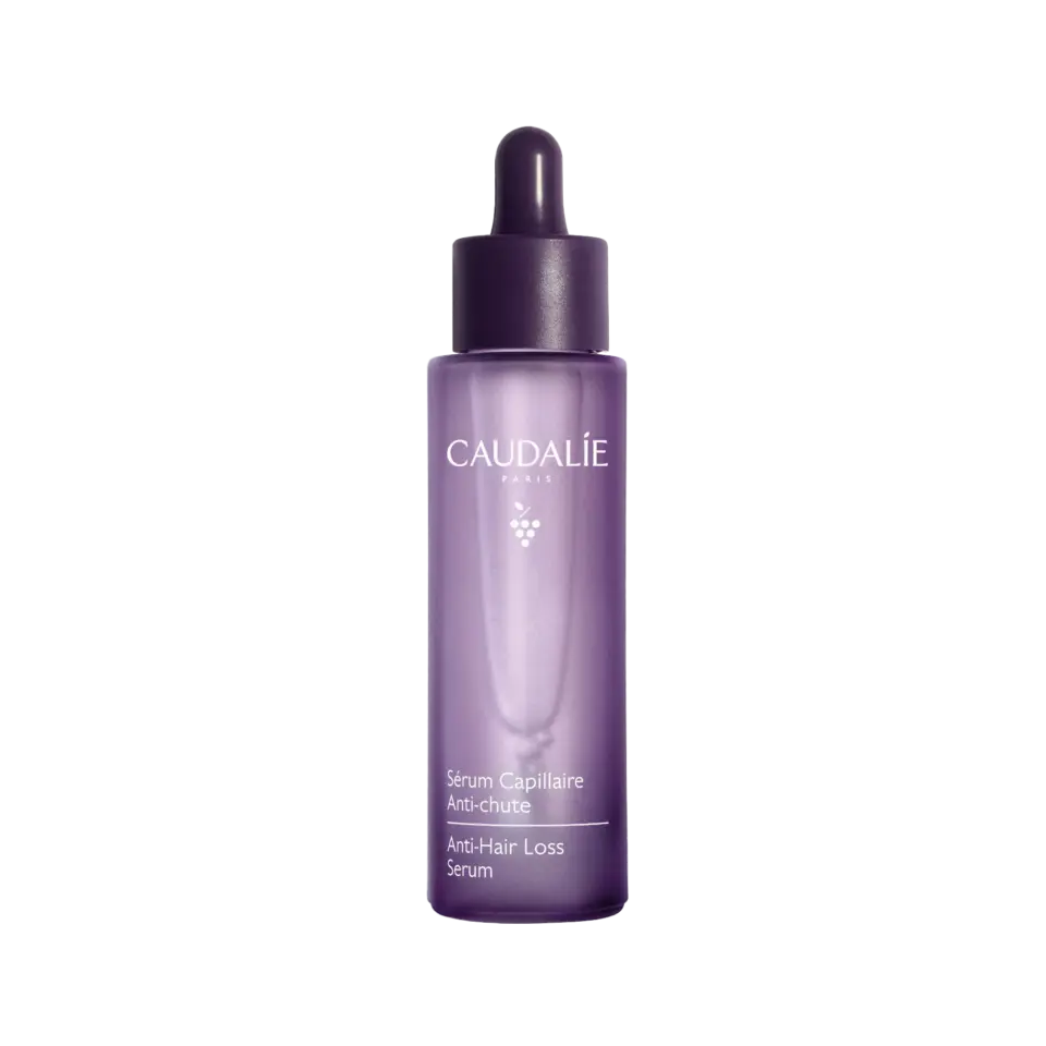 Purple bottle of Caudalie Anti-Hair Loss Serum with dropper lid.