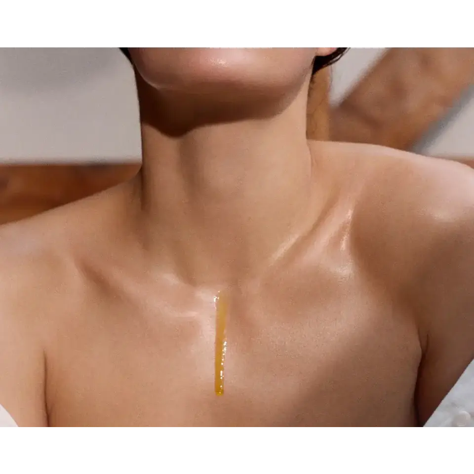 Oil dripping down a person's chest and neck.