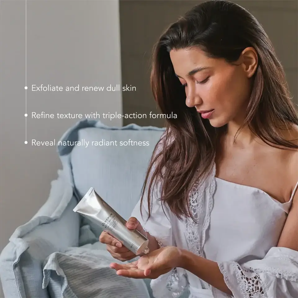 Woman applying skincare cream, text: Exfoliate, refine texture, reveal softness.
