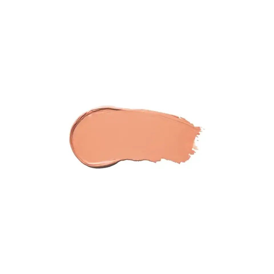 Peach-coloured cream swatch on white background.