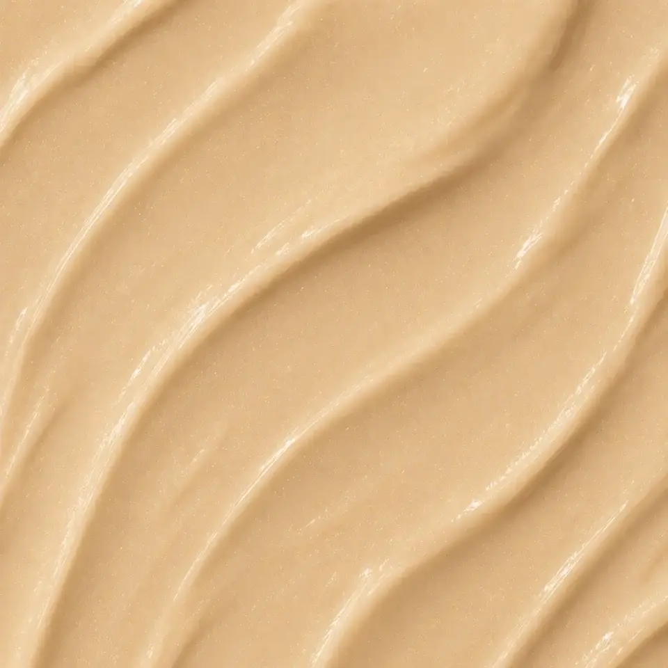 Smooth beige cream texture with wavy lines.