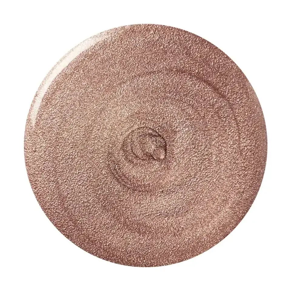 Shimmery bronze cream in a circular swirl pattern.