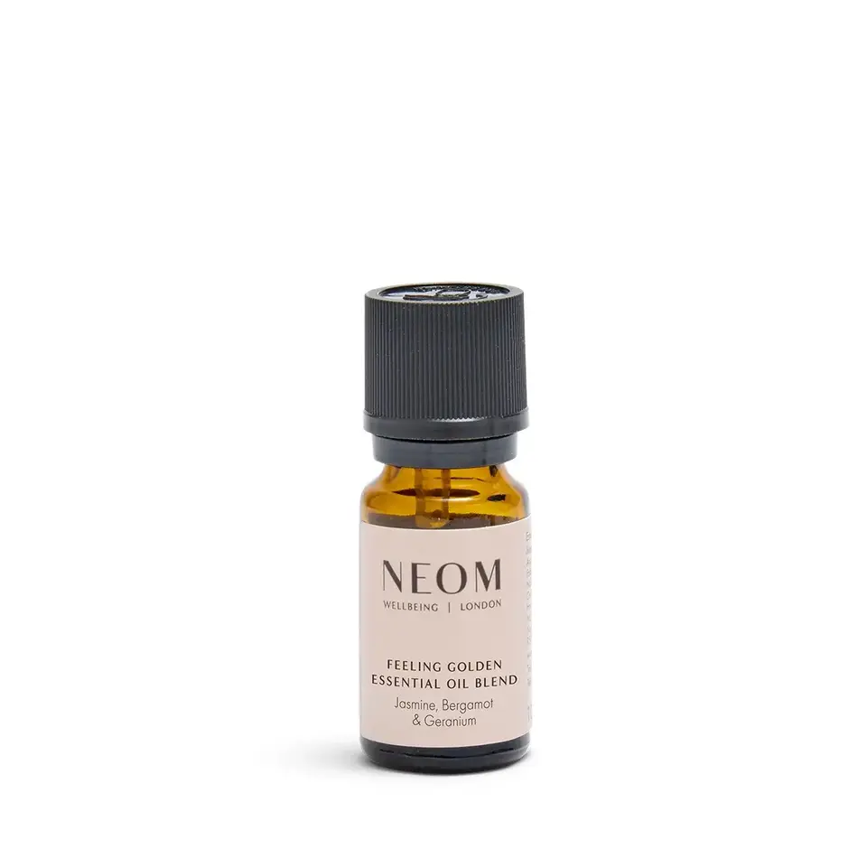 Brown bottle of NEOM Feeling Golden essential oil blend, jasmine, bergamot, geranium.