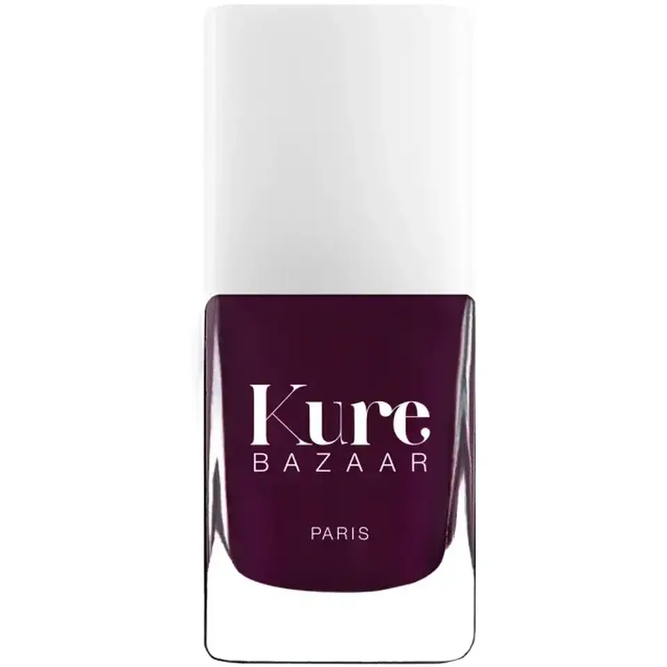Kure Bazaar nail polish bottle, dark purple shade, white cap.