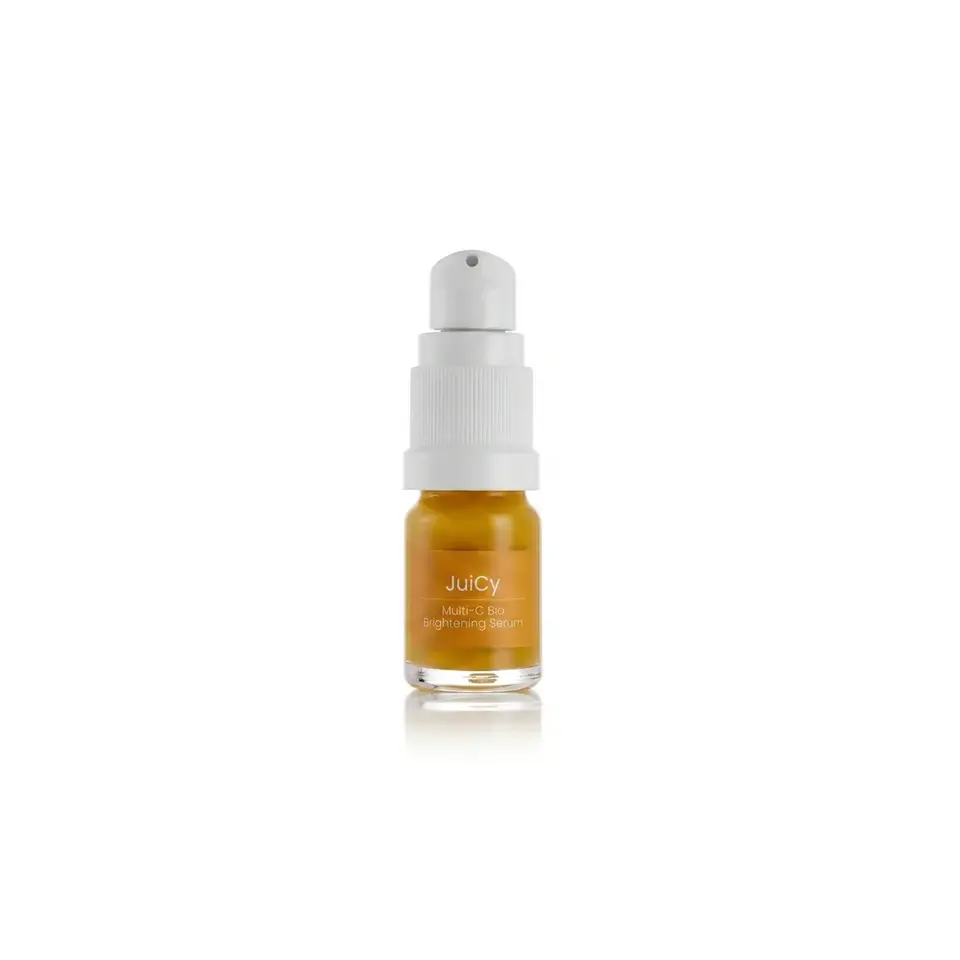 Juicy Multi-C Bio Brightening Serum in a small amber bottle with a white pump.