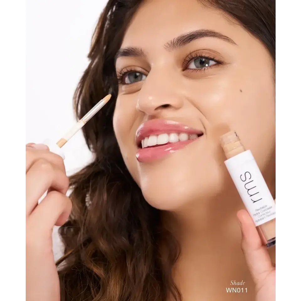 Person applying rms concealer, shade WN011, with a brush.