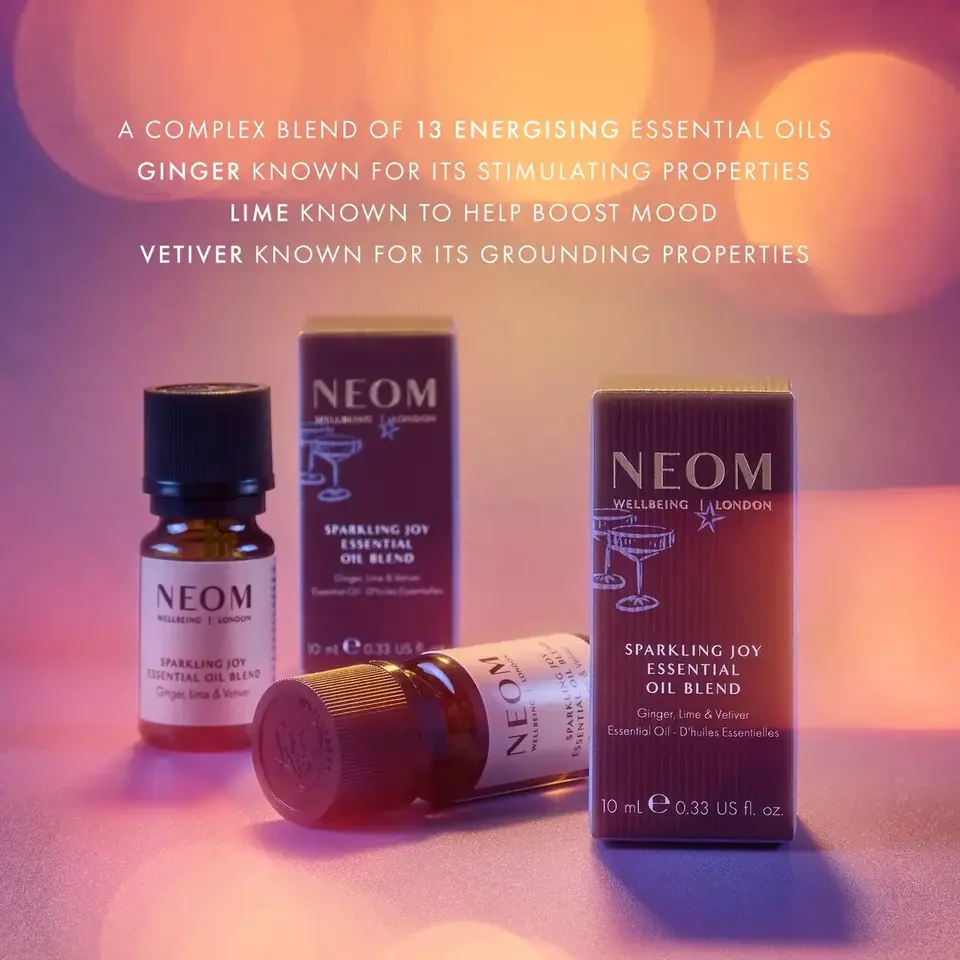 NEOM Sparkling Joy essential oil blend with ginger, lime, and vetiver. 10 ml bottle and packaging.