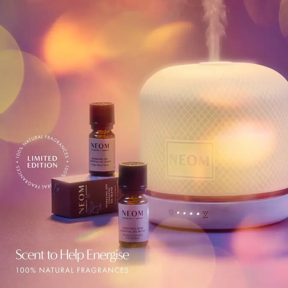 Aromatherapy diffuser with NEOM essential oils. Text: "Scent to Help Energise".