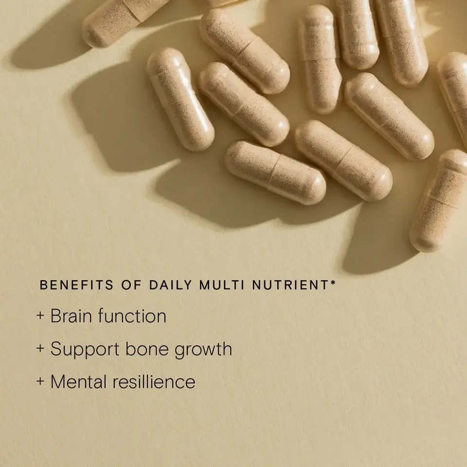Capsules on beige background with text: Benefits of Daily Multi Nutrient. Brain function, bone growth, mental resilience.