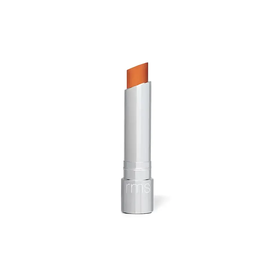 Silver lipstick tube with orange lipstick, "rms" on the base.