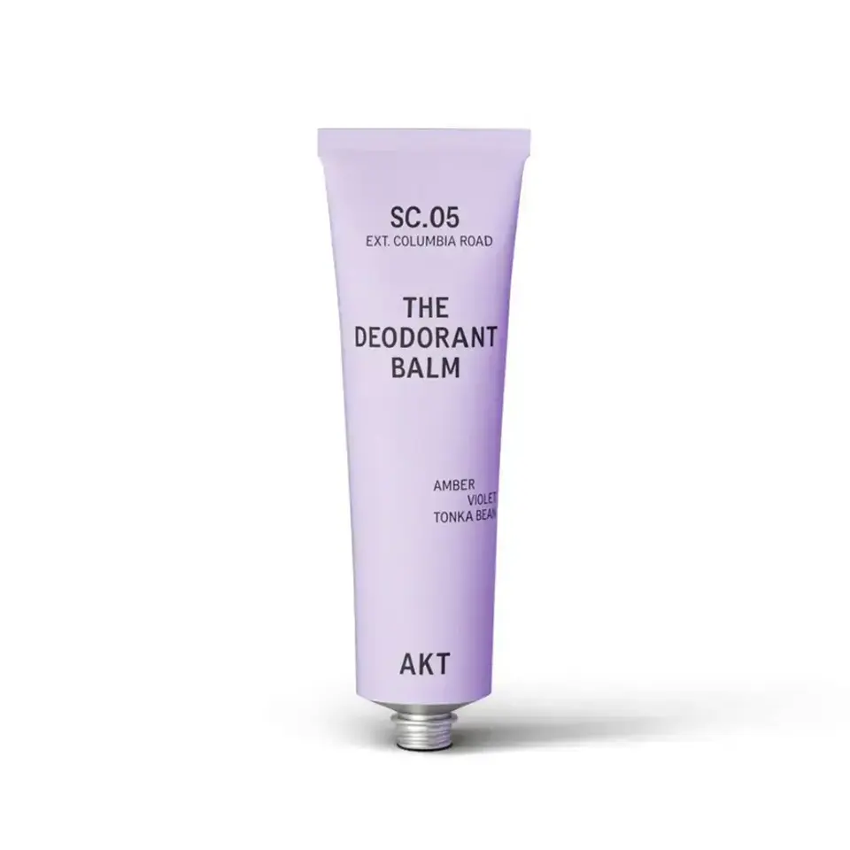 Lavender tube labelled "The Deodorant Balm" with notes of amber, violet, and tonka bean.