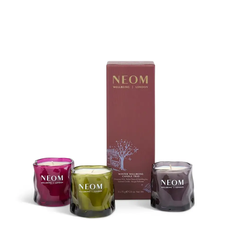 Neom Winter Wellbeing Candle Trio with red, green, and purple glass holders.