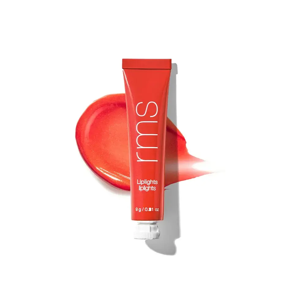 Red tube of rms Liplights, 9g, with a smear of red lip gloss behind.