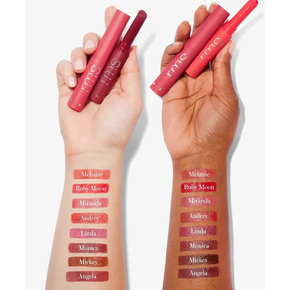 Two hands holding rms lipsticks with swatches on forearms, shades labelled Melanie to Angela.